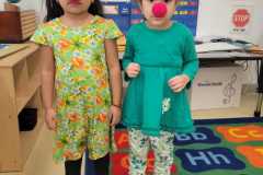 Two students from the Catholic Charities Charles F. Murphy Early Childhood Development Center celebrate Red Nose Day in school.