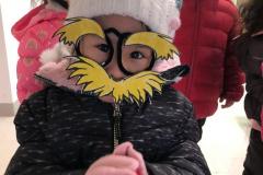 Young girl wears at a Lorax disguise in celebration of Read Across America and Dr. Seuss' birthday.