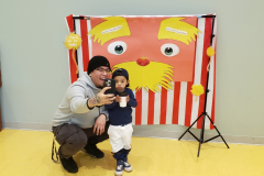 Father and son pose in front of a Lorax backdrop during a Read Across America celebration held at the Catholic Charities Charles F. Murphy Early Childhood Development Center in the Coney Island section of Brooklyn, New York.
