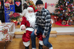 Member of the Catholic Charities Pete McGuiness Older Adult Center poses with Santa during their Christmas party.