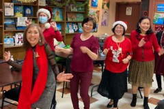 Members of the Catholic Charities Bayside Older Adult Center sing and dance during their Christmas party.
