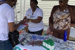 A group of people standing around a table for the Healthcare Education Project.