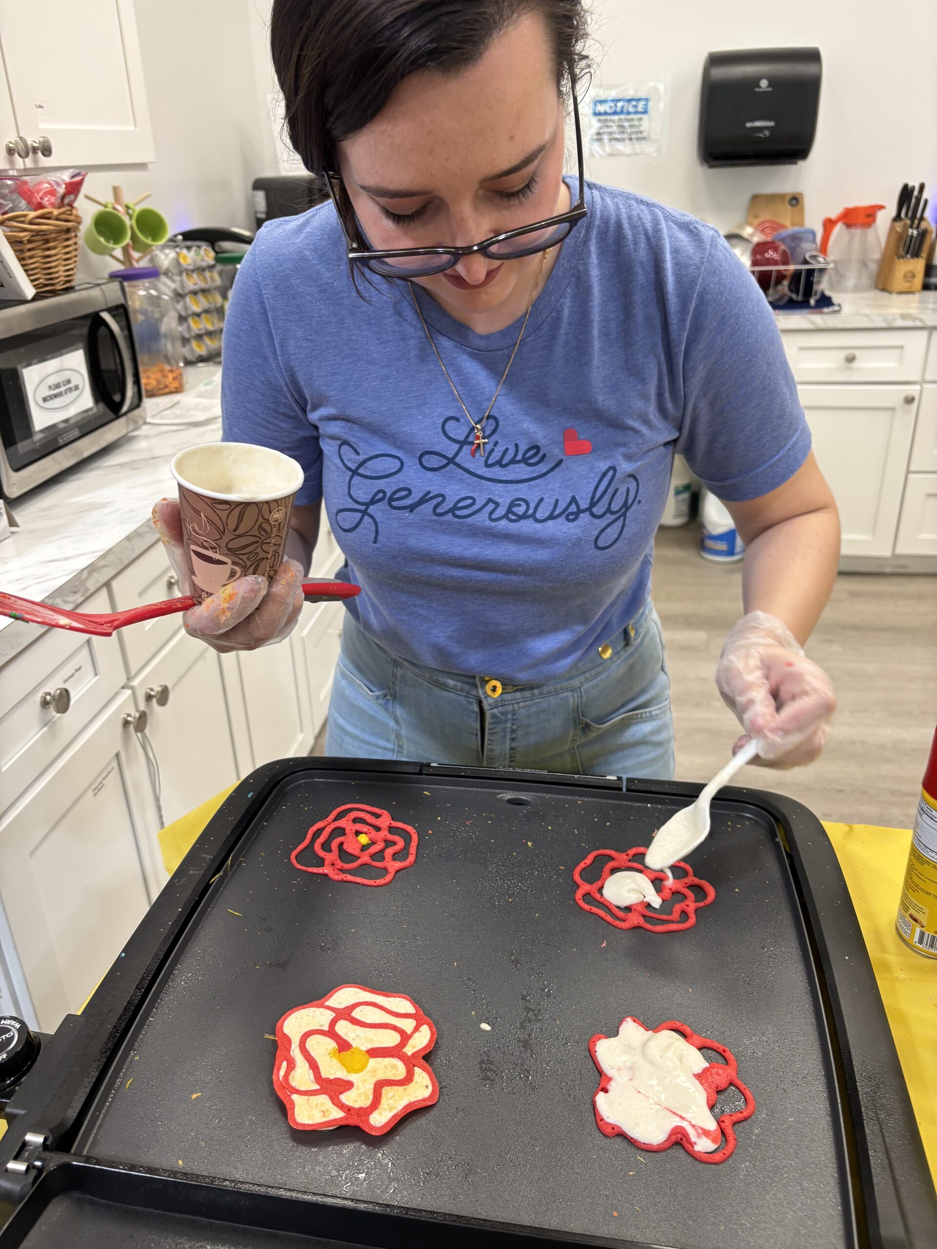 a participant is making pancakes in the shape of flowers